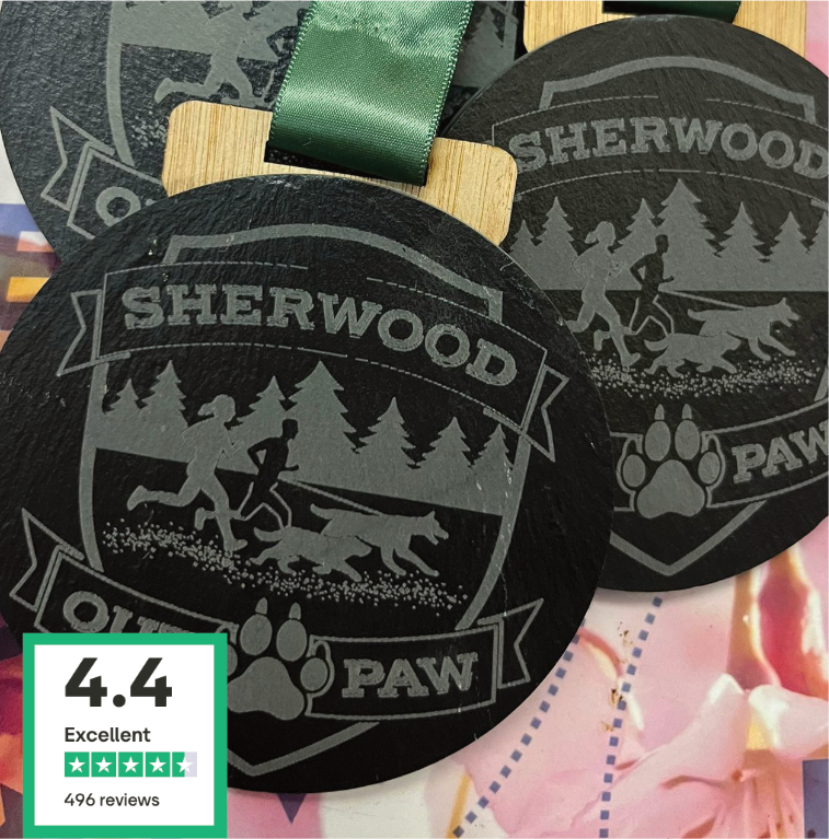 SHERWOOD Slate Medal featuring engraved logo of runners and dogs surrounded by trees